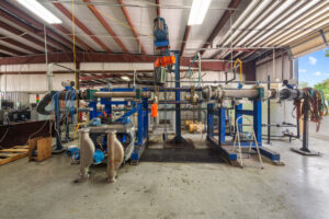 MFT technician performing Coriolis flow meter calibration at ISO 17025 accredited lab in Baytown Texas