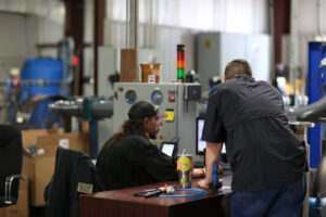 MFT technicians discussing fast flow meter calibration turnaround service