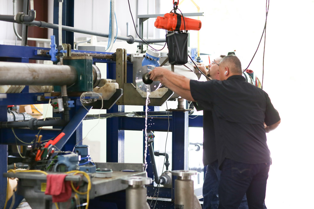 Expert technician calibrating pressure and temperature instrumentation with ISO 17025 standards