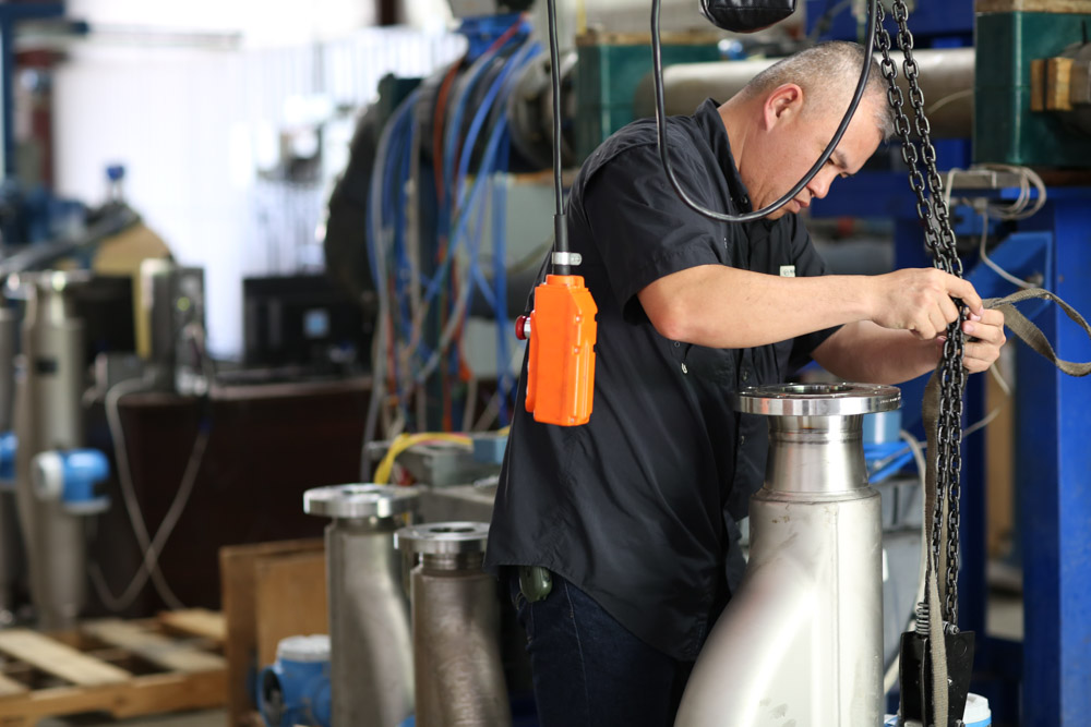 Technician performing ISO 17025 precision calibration on flow measurement equipment